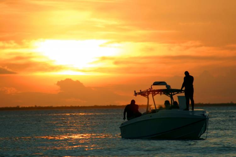 fishing boat on the water at sunset