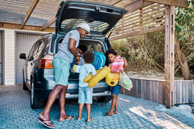 family loading car for vacation