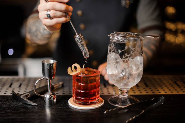 bartender making whiskey cocktail