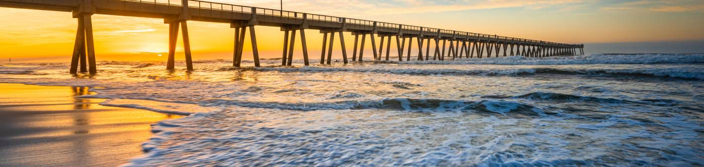 pier at beach at sunset